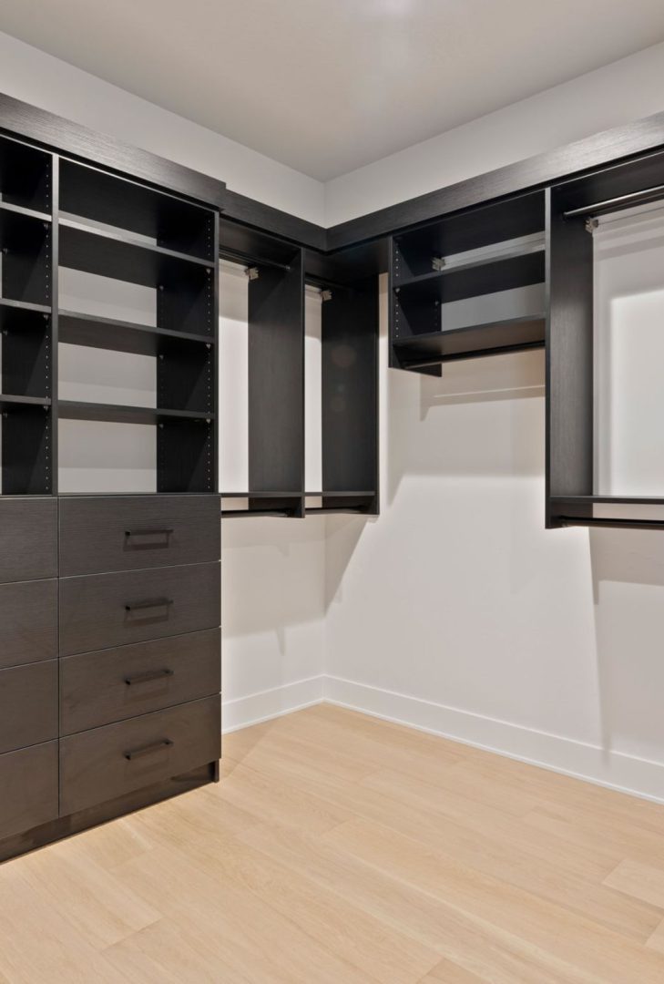 Häfele black round closet rod featured in an Anthem Pacific show home, providing a sleek, modern solution for closet organization and adding a contemporary touch to the wardrobe space.