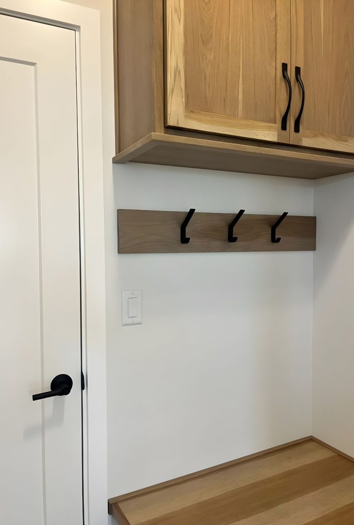 Sure-Loc Modern Coat Hook in satin nickel finish featured in a Greenstone Builder show home, used to create a stylish and functional space for hanging coats and bags.