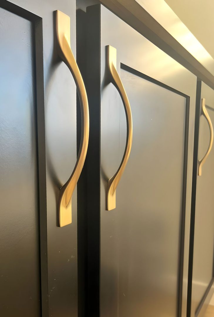 Amerock Uprise cabinet pulls in a satin nickel finish installed in a Greenstone Builder show home kitchen, adding a sleek, modern touch to the cabinetry and highlighting contemporary design trends.