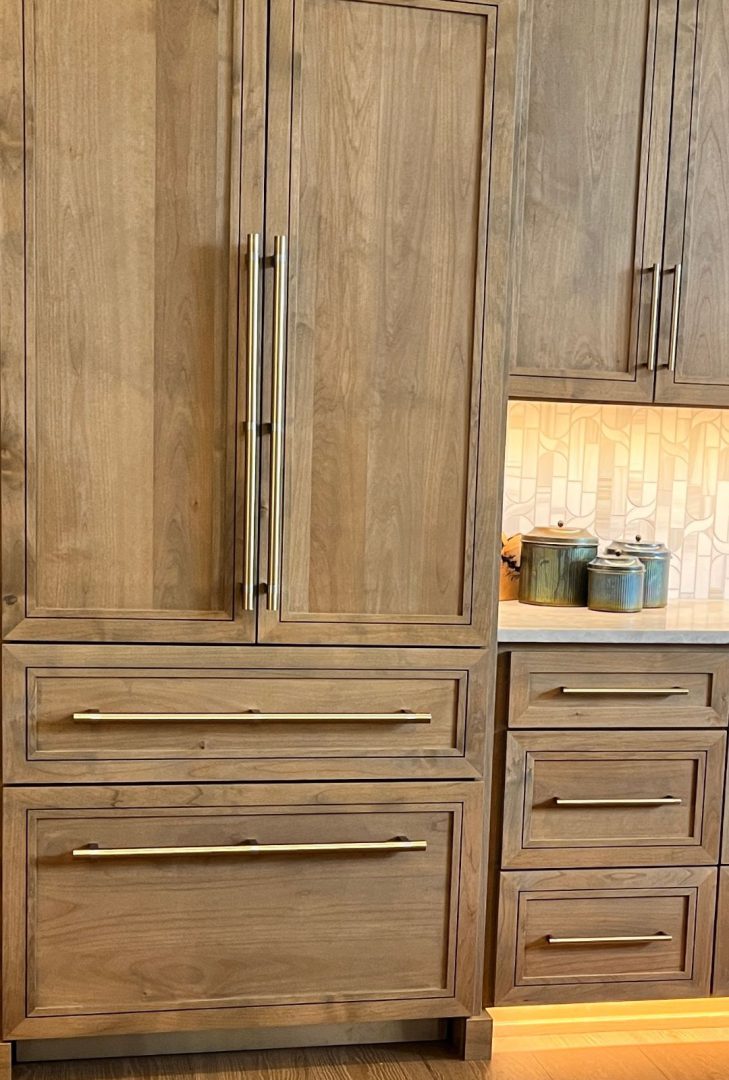 Top Knobs Bar Pulls in a brushed satin nickel finish featured in a Camden Homes kitchen, adding a sleek, contemporary touch to the cabinetry. The long, linear design complements the modern aesthetic while providing functionality and style.